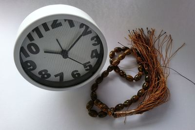 High angle view of clock on table against wall