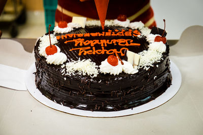 High angle view of chocolate birthday cake on table