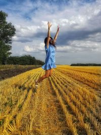 Full length of man standing on field against sky