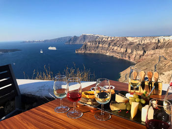 Panoramic view of people on table by mountain against sky
