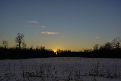 Snow covered landscape at dusk