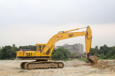 Construction machinery on site against sky