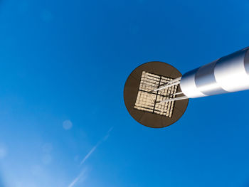 Low angle view of street light against clear blue sky