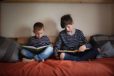 The brothers read together on two bunk beds in the nursery, the concept of kinship and childhood, 