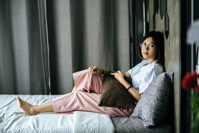 Portrait of teenage girl sitting on floor