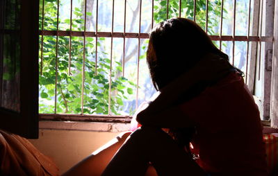 Woman looking through window