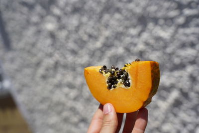 Cropped image of hand holding fruit