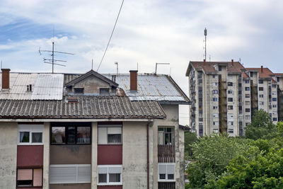 Low angle view of buildings in town against sky