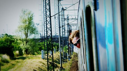 Man leaning while traveling in train