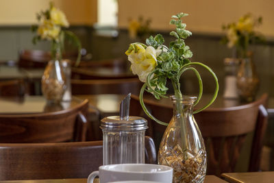 Flowers in glass vase on table