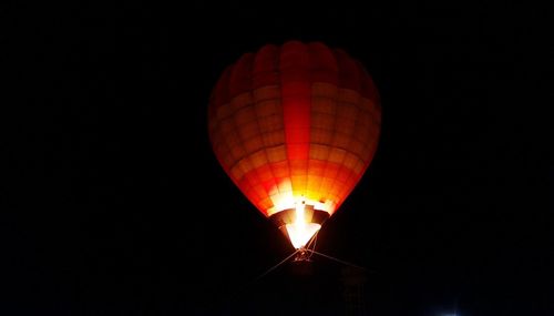 Low angle view of illuminated lanterns against clear sky at night