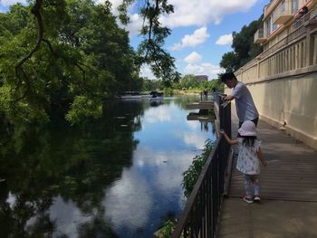 Side view of woman standing by lake