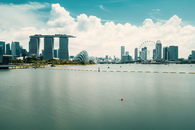 View of buildings in city against cloudy sky