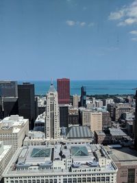 Cityscape and sea against sky