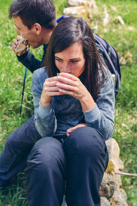 Young couple sitting on land