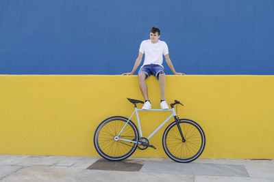 Man with disability sitting near bike