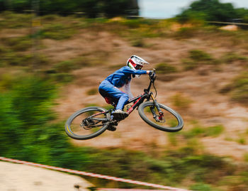 Man riding bicycle on field