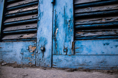 Rusty metal door on weathered wall