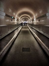 People in illuminated tunnel