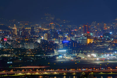 High angle view of illuminated city buildings at night