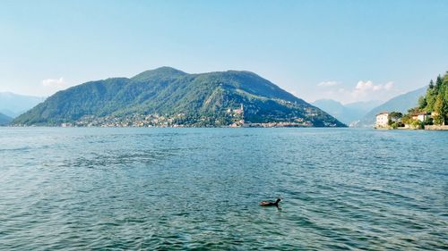 Scenic view of sea and mountains against sky