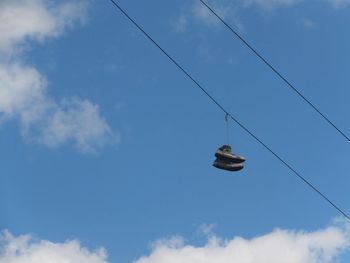 Low angle view of cables against blue sky