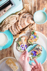 Delicious bruschetta with homemade bread, garnished with fig,soft cheese,pansies