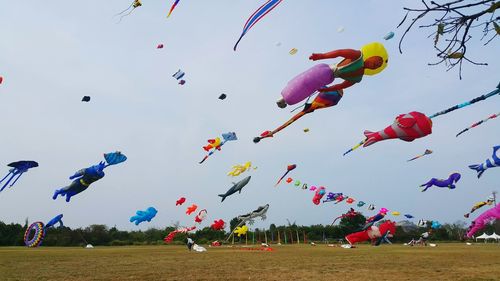 Low angle view of balloons flying against sky