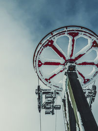 Low angle view of ferris wheel against sky