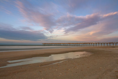 Scenic view of beach against sky during sunset