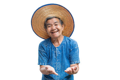 Portrait of happy senior woman gesturing while standing against white background