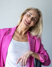 Portrait of young woman against white background