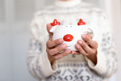 Unrecognizable woman holding with her hands a reindeer cup. christmas concept.