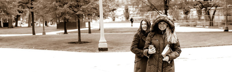 Portrait of young woman standing in park