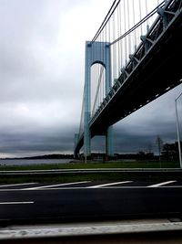 View of suspension bridge against cloudy sky