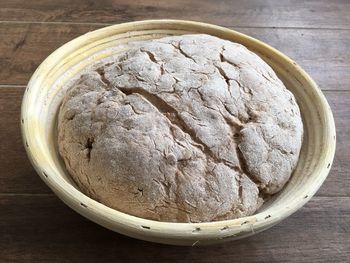 High angle view of sourdough bread in plate on wooden table