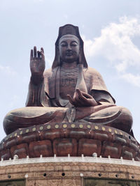 Low angle view of statue against sky