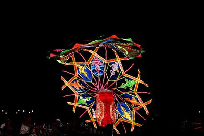Low angle view of illuminated ferris wheel at night