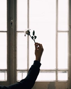 Close-up of hand holding glass window