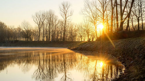 Scenic view of lake against sky during sunset