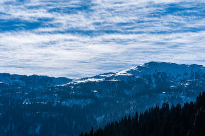 Panoramic view of mountains against sky during winter