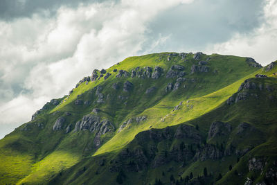 Scenic view of green mountains against sky