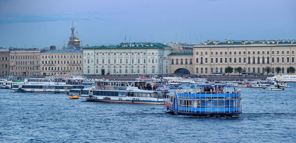 Boats in canal against buildings in city