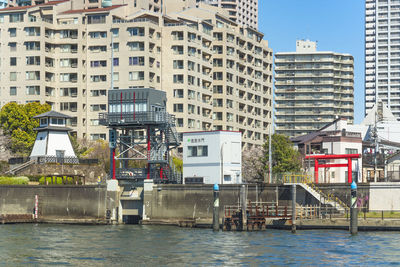 Sumiyoshi sluice gate and ishikawajima lighthouse along the tsukuda park of sumida river.