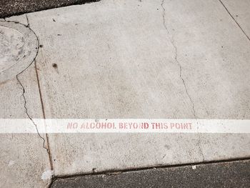 High angle view of text on footpath