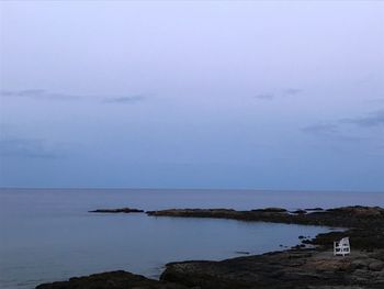 Scenic view of sea against sky at dusk