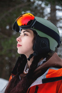 Skier, skiing, winter sports, female skier portrait. a beautiful girl stands against the backdrop of