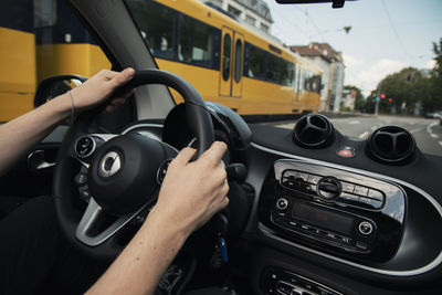 Midsection of man driving car