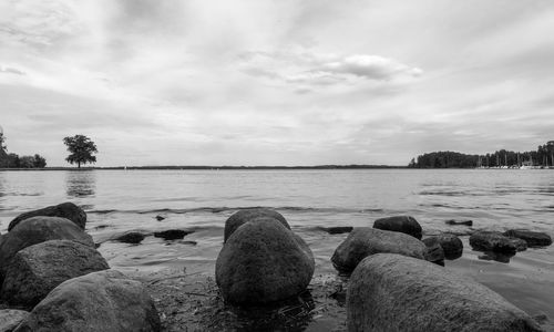 Rocks on beach against sky