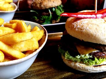 Close-up of burger and vegetables on table